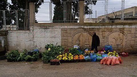 A Palestinian street vendor displays fruits and vegetables for sale in the West Bank city of Tulkarem on Sunday, Jan. 18, 2026.