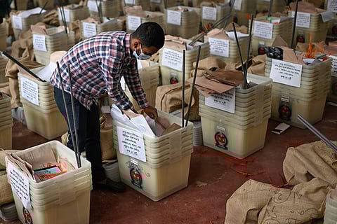 An official checks ballot boxes and voting papers before its distribution to various polling centers ahead of the national parliamentary election, in Dhaka, Bangladesh, Wednesday, Feb. 11, 2026. 
