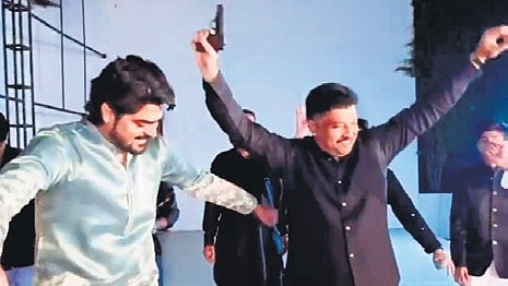 A video grab of Matin Patel, a follower of minister Priyank Kharge, dancing with a pistol in Kalaburagi.