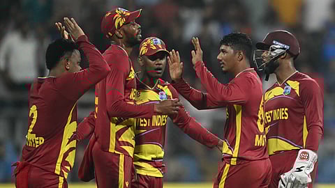 West Indies' Gudakesh Motie celebrates with teammates after taking the wicket of England's captain Harry Brook during the 2026 ICC Men's T20 Cricket World Cup group stage match between England and West Indies at the Wankhede Stadium in Mumbai.