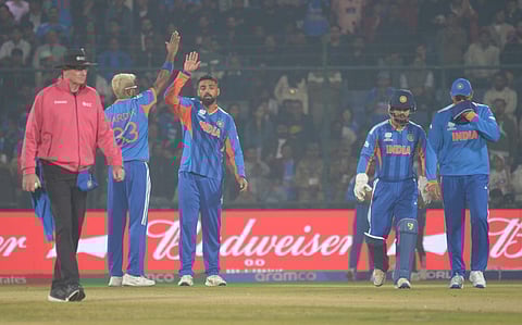 Varun Chakravarthy celebrates a wicket with Hardik Pandya.
