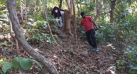 Power department officials trekking rly seven kilometres to Dabbalapadu, a remote hilltop village under Rompalle panchayat in Ananthagiri mandal.