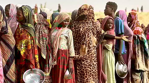Refugees lining up for food rations in a makeshift encampment near the town of Tawila in Sudan's western Darfur region