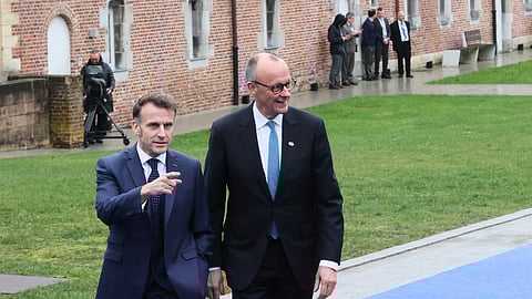 French President Emmanuel Macron, left, and Germany's Chancellor Friedrich Merz arrive for the EU summit at Alden Biesen Castle in Bilzen-Hoeselt, Belgium, Thursday, Feb. 12, 2026