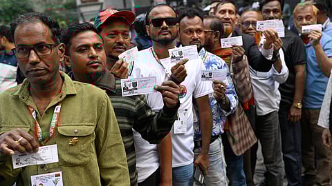 Voters wait in line outside a polling center to cast their ballots during the national parliamentary elections in Dhaka, Bangladesh, Thursday, Feb. 12, 2026.