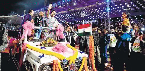 Chief Minister Rekha Gupta and other dignitaries greet athletes and spectators.