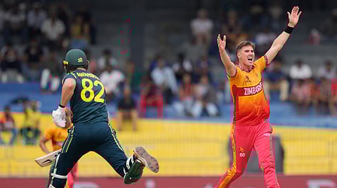 Zimbabwe's Bradley Evans, right, celebrates the wicket of Australia's Ben Dwarshuis, left, during the T20 World Cup cricket match between Australia and Zimbabwe in Colombo, Sri Lanka, Friday, Feb. 13, 2026.