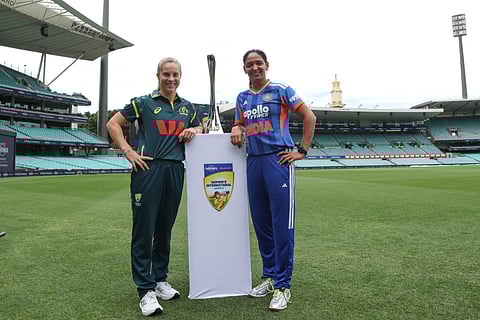 Sophie Molineux (R) and Harmanpreet Kaur pose with the multi-format trophy