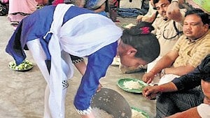 The anganwadi cook Sarmista Sethi is serving food at the community feast.