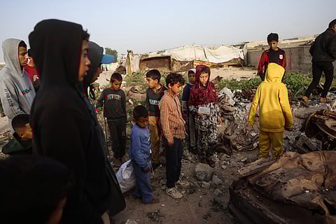 Displaced Palestinian youth gather at the site of an overnight Israeli strike which killed several people according to medics at Nasser Hospital in Khan Yunis, in the southern Gaza Strip on February 15, 2026.