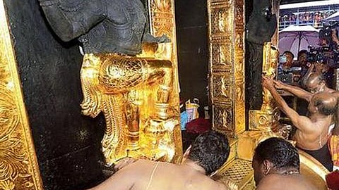 Priests busy reinstalling gold plated Dwarapalaka work at the Sabarimala Ayyappa temple.