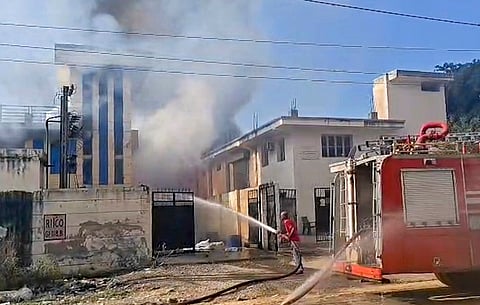 A firefighter tries to douse a fire at a chemical factory at the Khushkhera-Karouli Industrial Area, in Bhiwadi, Rajasthan.