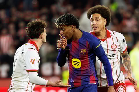 Barcelona's Lamine Yamal argues with Girona's Joel Roca during a Spanish La Liga soccer match.