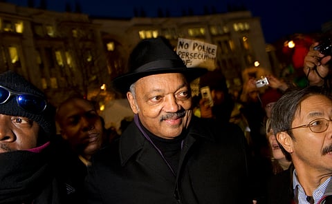 US civil rights leader Jesse Jackson (C) is ushered through the crowds to speak to protesters at the St. Paul's Occupy London camp on December 15, 2011.