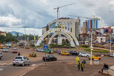 Cars drive through an intersection near a monument in Yaounde, Cameroon, Sept 12, 2025.