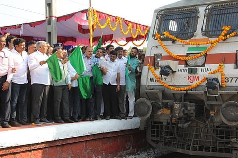 Union Minister of State for Railways V Somanna flags off a train that will have an additional experimental stoppage at Nayandahalli station, on Tuesday 