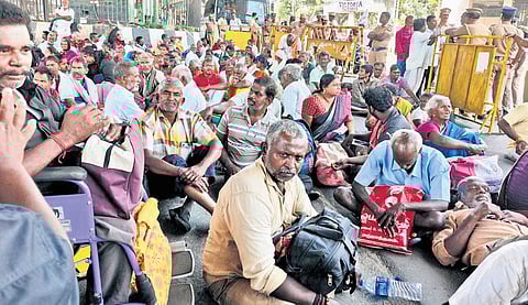 Disabled protesters wait near the CMBT bus stand at Koyambedu in Chennai.