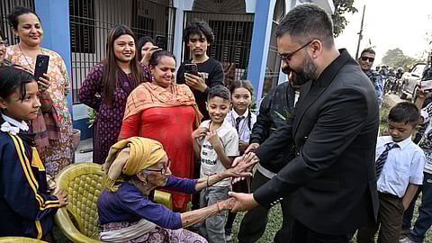 Balendra Shah (R), Rastriya Swatantra Party (RSP) election candidate and Kathmandu's former mayor greets supporters during a door-to-door election campaign at Gauriganj in Jhapa district on February 16, 2026.