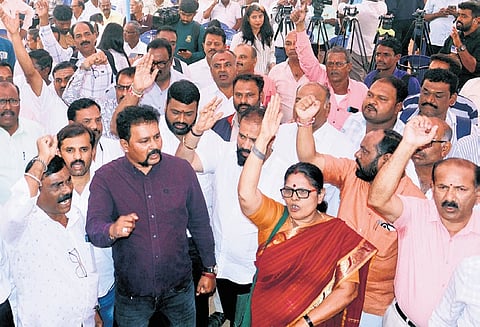 Transport employees protest before the strike was called off temporarily, at Freedom Park in Bengaluru on Thursday.