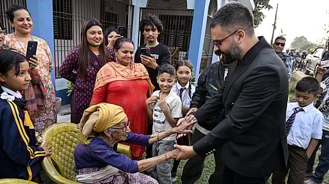 Balendra Shah (R), Rastriya Swatantra Party (RSP) election candidate and Kathmandu's former mayor greets supporters during a door-to-door election campaign at Gauriganj in Jhapa district on February 16, 2026.