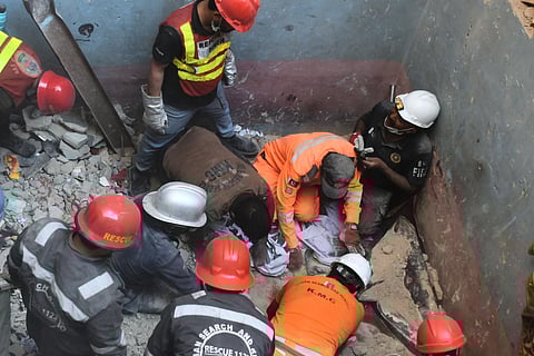 Rescue workers recover a body from the rubble following a gas explosion in an apartment building in Karachi, Pakistan, Thursday, Feb. 19, 2026.