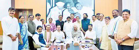 Chief Minister A Revanth Reddy and his Cabinet colleagues pose for a group photo along with AICC president Mallikarjun Kharge, Leader of the Opposition in the Lok Sabha Rahul Gandhi and AICC General Secretary KC Venugopal in Delhi on Thursday