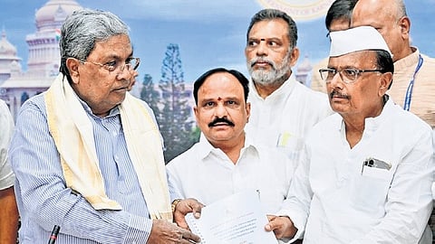 Karnataka State Policy and Planning Commission deputy chairman B R Patil submits the report to Chief Minister Siddaramaiah in Bengaluru on Thursday.