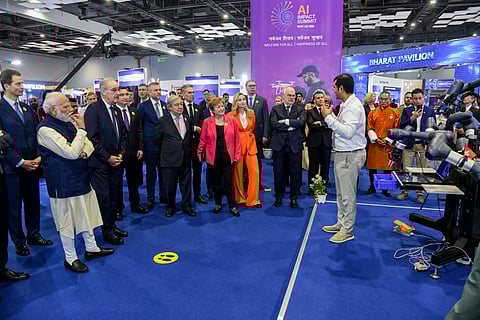 Prime Minister Narendra Modi and other dignitaries look on as CynLr Founder Gokul NA presents the company's 'Object Intelligence' powered robot 'CyRo' at the AI Impact Summit in New Delhi.