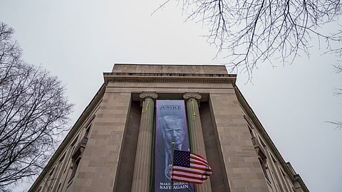 A banner showing President Donald Trump is hung from the Department of Justice, Thursday, Feb. 19, 2026, in Washington.