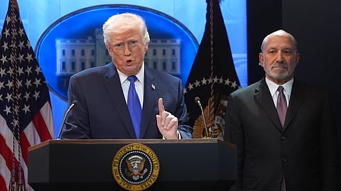 President Donald Trump speaks during a press briefing at the White House, Friday, Feb. 20, 2026, in Washington. Beside the President is Commerce Secretary Howard Lutnik. 