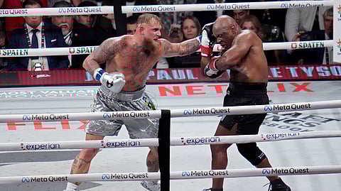 Jake Paul hits Mike Tyson during their heavyweight boxing match, Friday, Nov. 15, 2024, in Arlington, Texas.