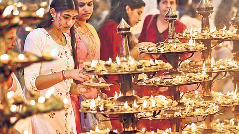Devotees lighting lemon lamps in front of Attukal Bhagavathy temple in Thiruvananthapuram ahead of annual pongala festival. 