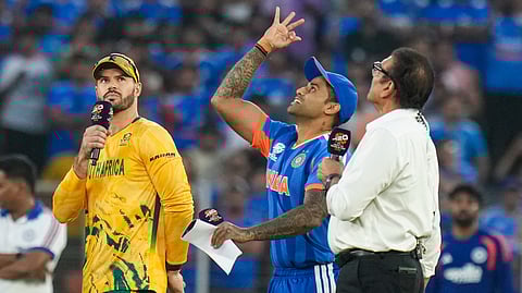 India's captain Suryakumar Yadav, centre, flips the coin as South Africa's captain Aiden Markram, left, takes the call during the toss