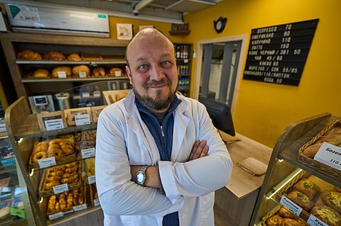 Denis Maksimov poses for a photo in the sales area of his bakery outside Moscow, Russia, on Wednesday, Feb. 18, 2026