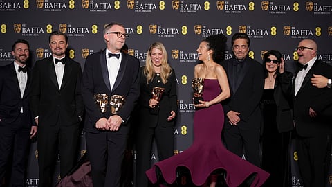 Andy Jurgensen, from left, Leonardo DiCaprio, Teyana Taylor, Paul Thomas Anderson, Sara Murphy, Chase Infiniti, Benicio Del Toro, Cassandra Kulukundis, and Michael Bauman pose with the awards for best director, cinematography, and adapted screenplay for 'One Battle After Another' at the 79th British Academy Film Awards, BAFTA's, in London, Sunday, Feb. 22, 2026