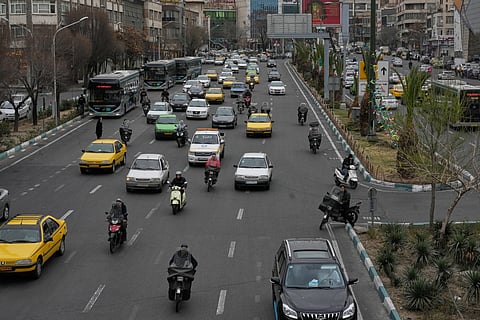 Vehicles drive in downtown Tehran, Iran, Tuesday, Feb. 24, 2026.