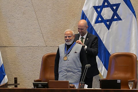 Israel's Parliament Speaker Amir Ohana presents a medal to Indian Prime Minister Narendra Modi , after addressing lawmakers in the Knesset, Israel's parliament, in Jerusalem.