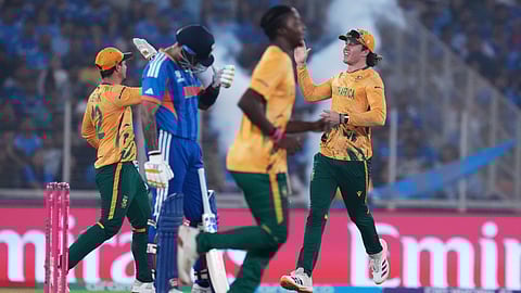 South Africa's Dewald Brevis, right, runs in after taking the catch to dismiss India's captain Suryakumar Yadav, second left, during the T20 World Cup cricket match between India and South Africa in Ahmedabad, India, Sunday, Feb. 22, 2026
