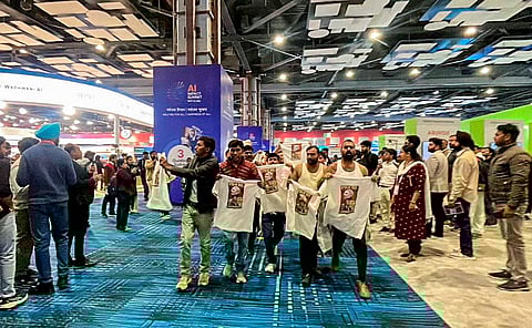 In this image received on Feb. 20, 2026, Indian Youth Congress (IYC) workers stage a 'shirtless protest', walking around holding T-shirts with slogans against the government and the India-US trade deal printed on them, at the AI Impact Summit, in New Delhi. 