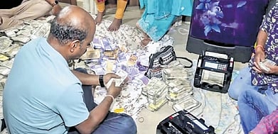 Vigilance officials count seized currency notes & Debabrata Mohanty 