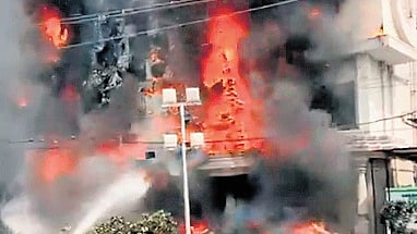 Firefighters spray water onto flames as smoke billows from Mangala Gowri Shopping Mall, Jubilee Hills