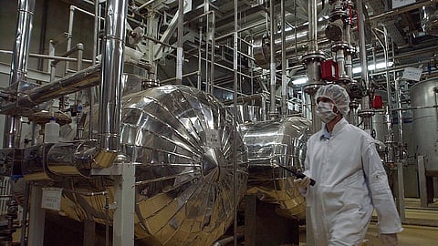 An Iranian security official in protective clothing walks through part of the Uranium Conversion Facility just outside the Iranian city of Isfahan, March 30, 2005.
