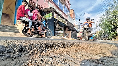 Motorists traveling over a damaged road in Madhavaram on Friday