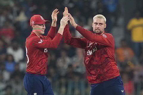 England's Will Jacks, right, celebrates with captain Harry Brook the wicket of New Zealand's Glenn Phillips during the T20 World Cup cricket match between England and New Zealand in Colombo.