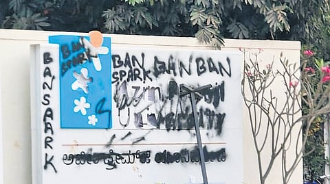 Black paint on the signboard of the Azim Premji University.