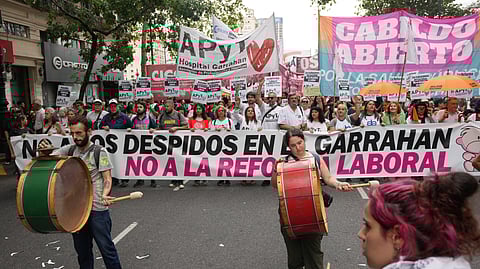 Protesters rally during a march by trade unions and opposition groups against a labor reform bill proposed by President Javier Milei's government in Buenos Aires, Argentina, Thursday, Feb. 19, 2026.