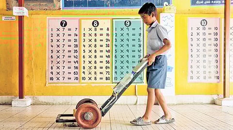 M Muhammad Asif using the solar-powered cleaning tool he created after noticing his mom at home and women working in school exert too much to clean the floors 