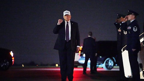President Donald Trump holds up a fist after disembarking Air Force One at Palm Beach International Airport in West Palm Beach, Fla., Friday, Feb. 27, 2026.