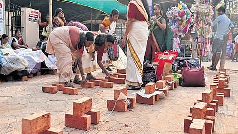 Devotees setting up hearths to secure space for offering Pongala 