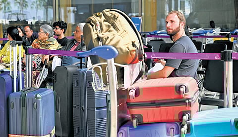 Passengers wait at Kempegowda International Airport in Bengaluru on Monday, following cancellation of several flights to West Asian countries 